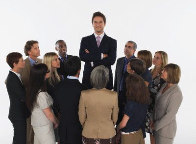 Group of Businesspeople Staring at Tall Man